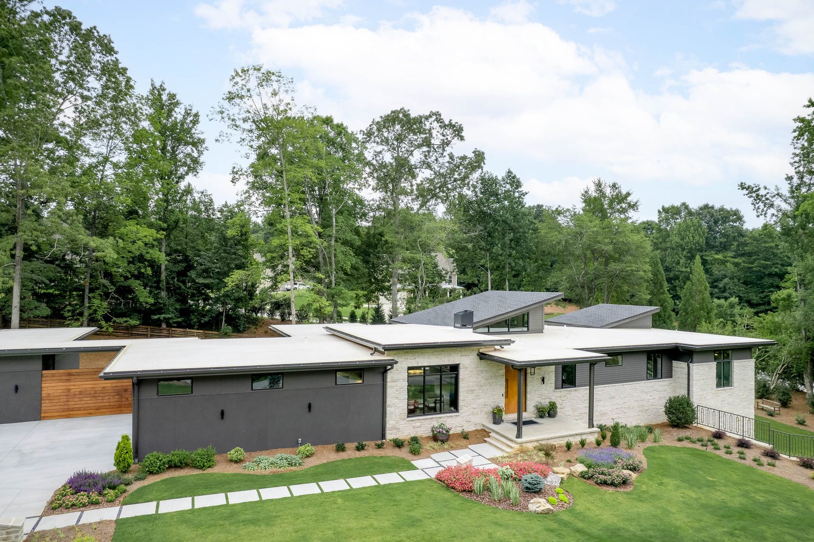 Front elevation with cedar-clad garage and entry — The Ortiz Home, custom home built by Ironwood Construction Group in Sugar Hill, Georgia