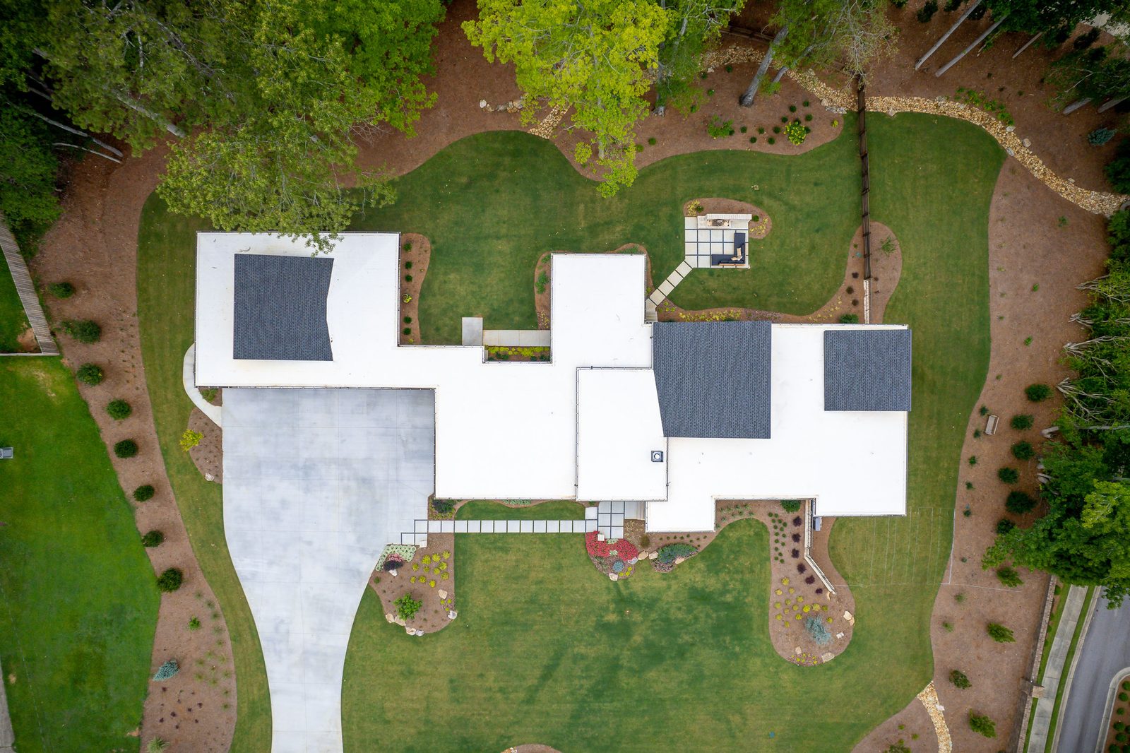 Aerial view over the roof, drive and landscaping — The Ortiz Home, custom home built by Ironwood Construction Group in Sugar Hill, Georgia