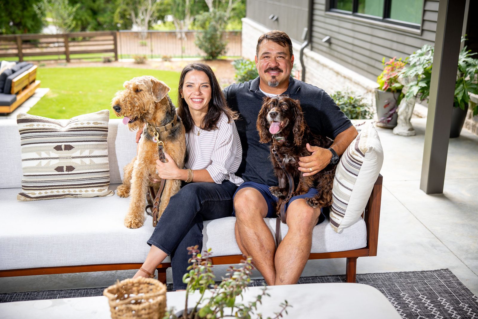 Family portrait on the covered patio — The Ortiz Home, custom home built by Ironwood Construction Group in Sugar Hill, Georgia