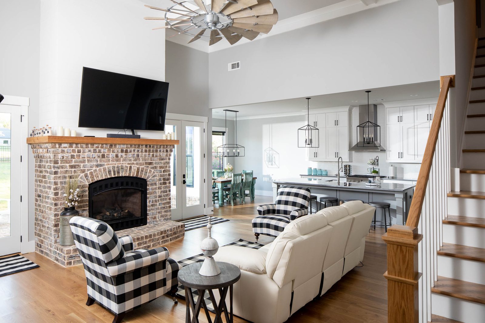 Great room with windmill fan and staircase — Glausier, custom home built by Ironwood Construction Group