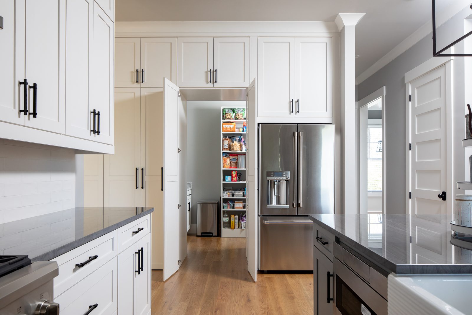 Butler's pantry doorway beside the refrigerator — Spring 2020 Custom Home, custom home built by Ironwood Construction Group