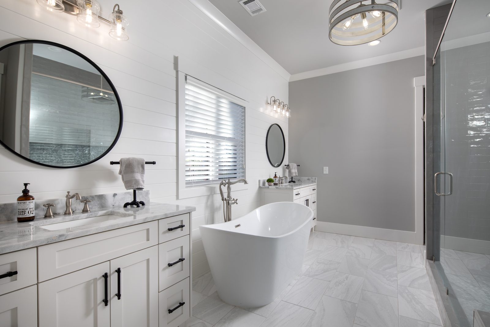 Primary bath with freestanding tub and double vanity — Spring 2020 Custom Home, custom home built by Ironwood Construction Group